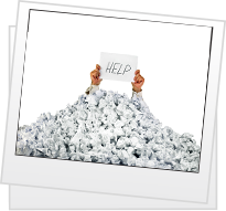 Man holds up help sign buried under large pile of paper