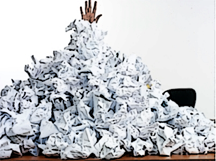 man buried under pile of paper