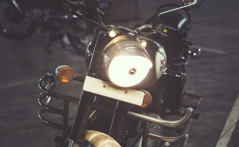 Vintage motorbike at night with the headlight on